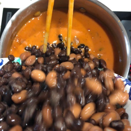 adding beans to pot