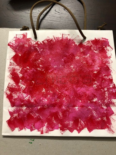 Valentine's Day Decorated Gift Bag - front of the bag covered with splotches of red paint
