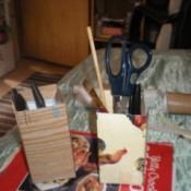 Recycled Butter Boxes Used as Pencil Holders - boxes with pens, pencils, scissors, and more inside