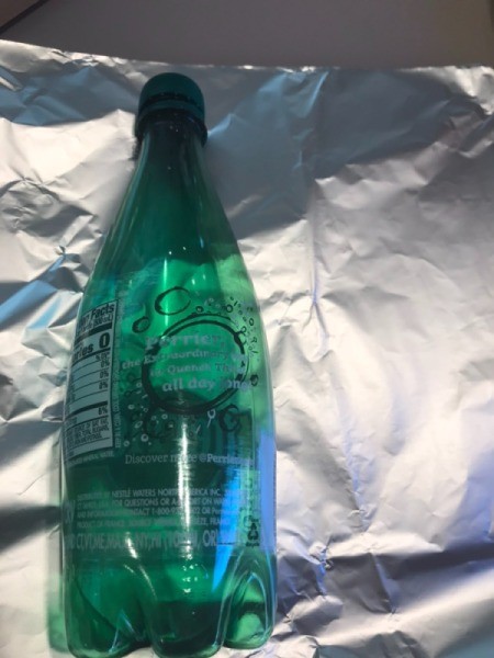 Making a Recycled Rocketship - bottle laying on a piece of foil