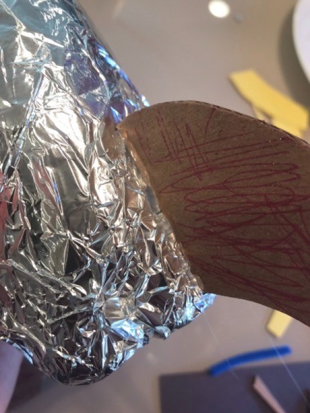 Making a Recycled Rocketship - glue fins to bottle