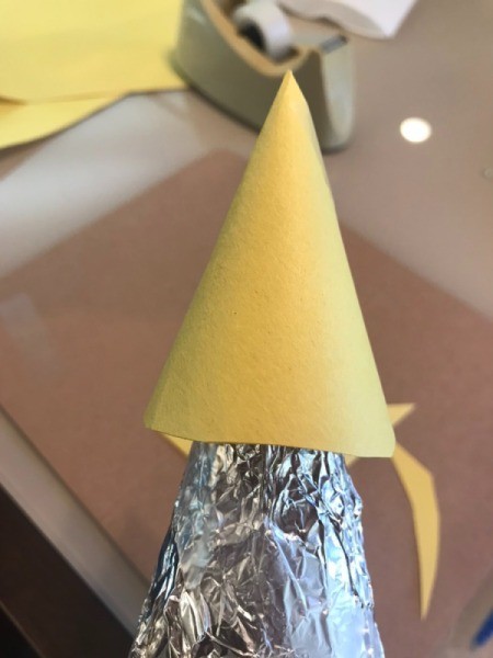 Making a Recycled Rocketship - glue nose cone over the top and neck of the bottle