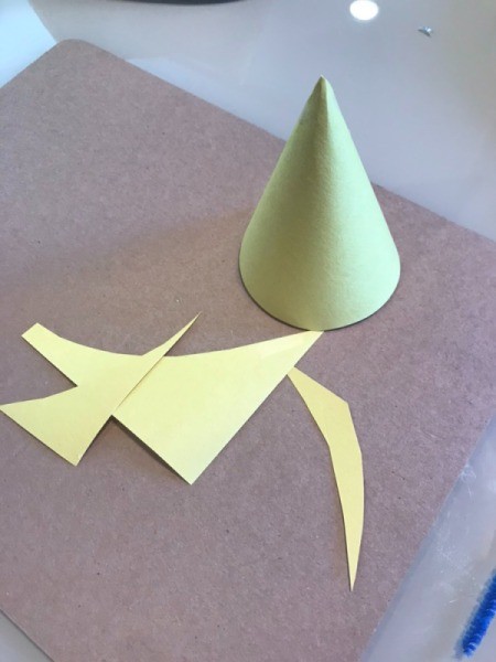 Making a Recycled Rocketship - roll a piece of colored paper into a cone shape for the nose