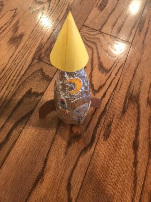 Making a Recycled Rocketship - finished rocketship with stickers added to foil covering