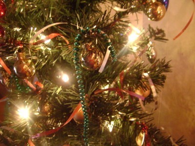 Mardi Gras beads used as candycane Christmas tree ornaments.