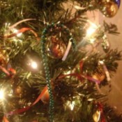 Mardi Gras beads used as candycane Christmas tree ornaments.