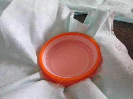 Double Duty Pin Cushion - cap removed and placed upside down on wrong side of the fabric