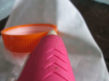 Double Duty Pin Cushion - with cotton covered side place cap on the wrong side of the fabric and begin gluing