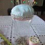 Double Duty Pin Cushion - finished project with straight pins in cushion and safety pins in the container