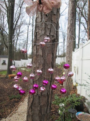 A wind chime made from a metal hanger and colorful bells.