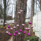 A wind chime made from a metal hanger and colorful bells.