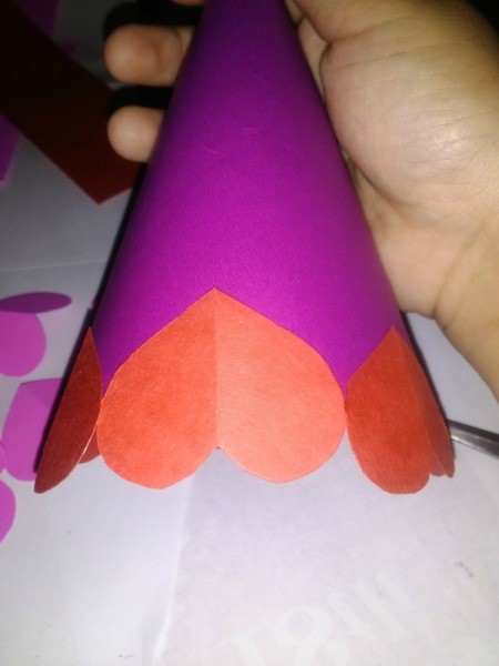 Making a Paper Valentine Tree - glue the hearts around the cone starting at the bottom