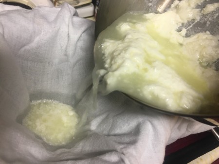 pour curdled milk to strain curds from whey