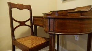 Value of a Vintage Desk and Chair - curved inlay wood desk with drawers and cubbies plus matching cane seat chair