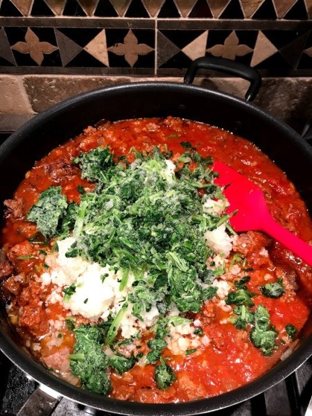 added kale and cauliflower to sauce in pan