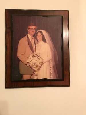 A framed picture of a wedding couple.