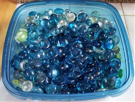 Glass decor contained in a plastic container.