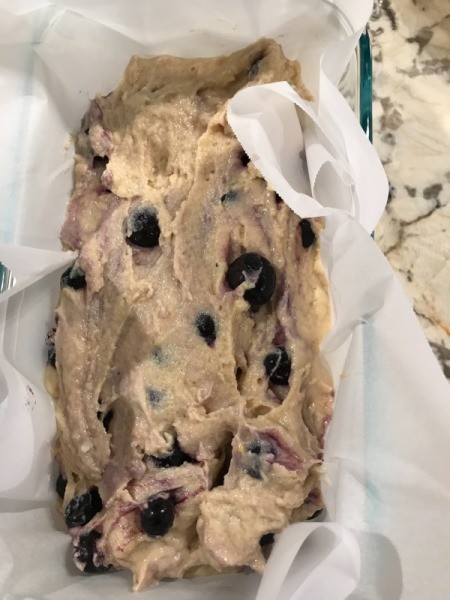 cake batter in lined loaf pan