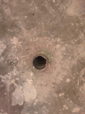 Plumbing Help for Low Income Homeowners - pipe protruding from basement floor