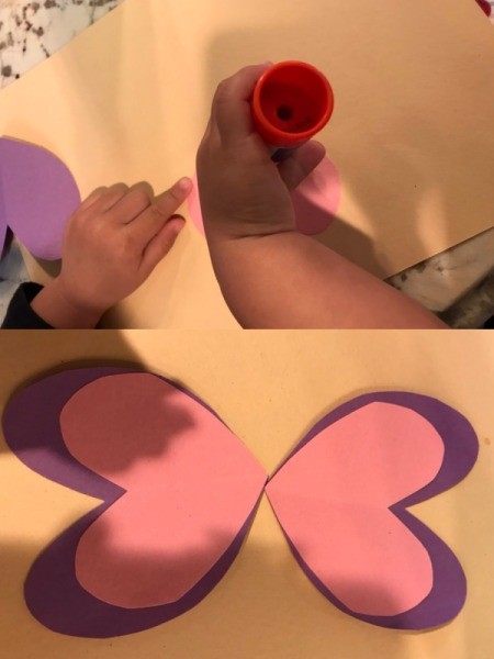 Imaginary Clothespin Flying Butterfly - child using glue stick to construct the wings