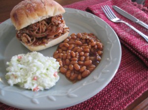 Pulled Pork sandwich, beans & coleslaw on plate