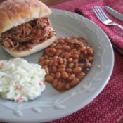 Pulled Pork sandwich, beans & coleslaw on plate