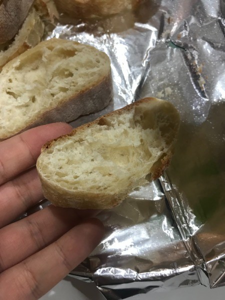 A piece of bread cut from the loaf with scissors.