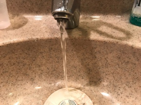 A faucet with running water.
