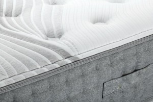 A bare bed mattress.