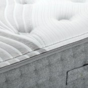 A bare bed mattress.
