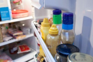 A row of condiments in the refrigerator.