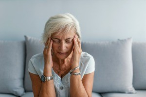 A woman with a strong headache.