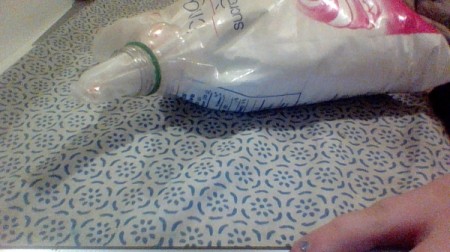 Using a recycled bottle and cap to seal powdered sugar.