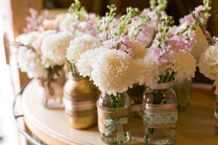 Simple flowers in jars for a wedding.