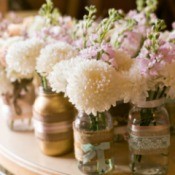 Simple flowers in jars for a wedding.