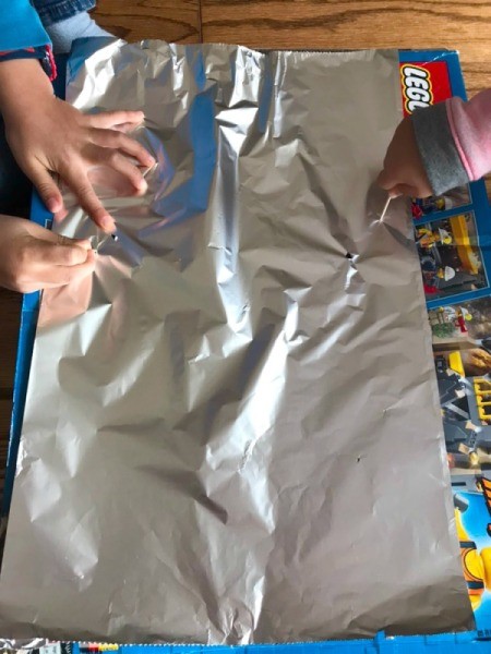 Foil Lined Mason Jar Light - kids poking holes in foil with toothpicks