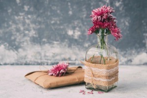 Small glass vase wrapped in burlap, lace and twine.