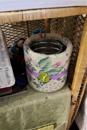 Camouflage Your Trashcan - small trash can on rattan shelf