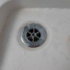 Replacing the Silicone Around a Shower Drain - drain with clear caulking
