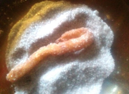 rolling Churros in sugar