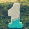 1 shaped Piñata sitting in the grass