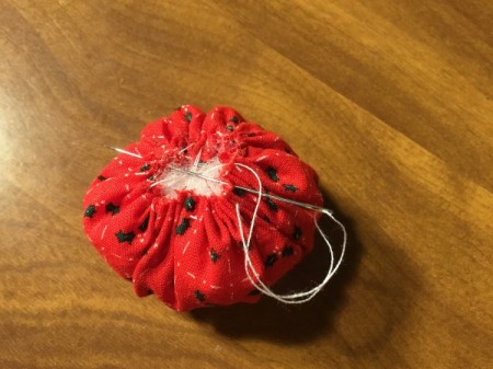 Bottlecap Pincushion - pull the thread to gather, stuff, and sew closed