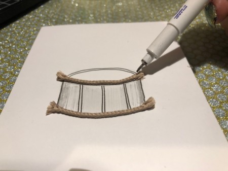 Drum Beat Card - glue a piece of cord on each downward curve of the drum, also trace around the top edge of the drum and add a second dark line below at the same curvature