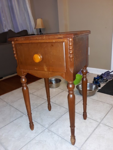 A small end table with a large drawer.