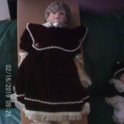 Value of a Karnival Kids Collection Porcelain Doll - doll in black dress with very large collar