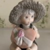 Value of Kim Anderson's Enesco Figurines - child with straw hat holding a pink heart