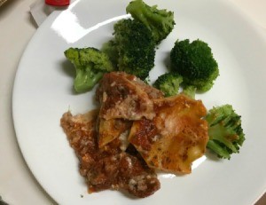 Lasagne on plate with broccoli