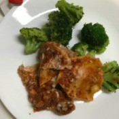 Lasagne on plate with broccoli