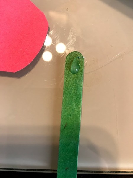 Making a Paper Hand Shaped Flower Bookmark - add drop of hot glue to top of stick