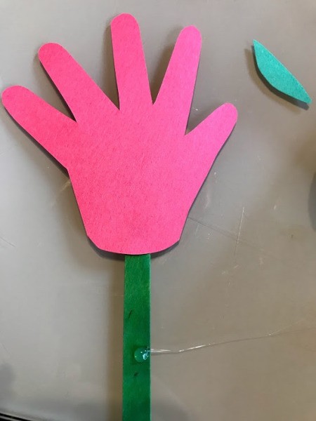 Making a Paper Hand Shaped Flower Bookmark - glue on hand shape and add glue further down the stick